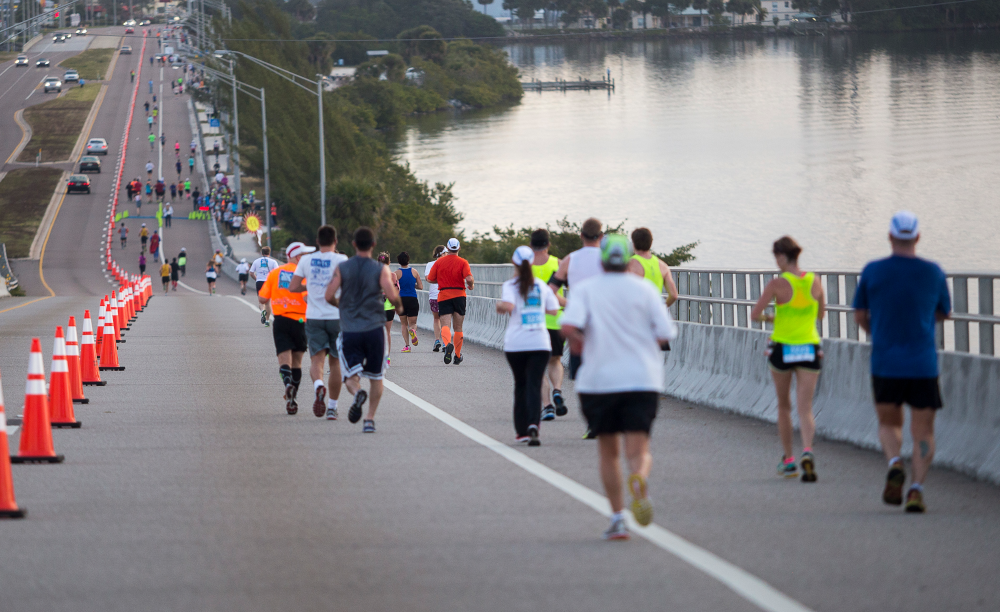 Runners cross the bridge in Space Coast Marathon